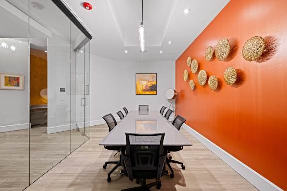 A conference room with a long table and chairs.