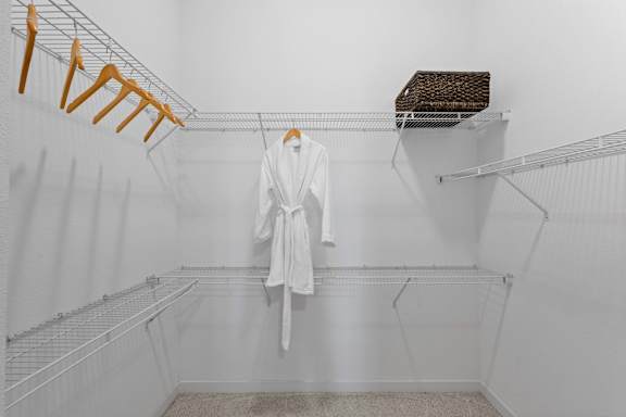 A white bathroom with a towel hanging on a rack.