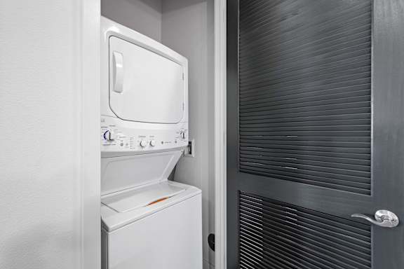 A white dishwasher is in a small kitchen.
