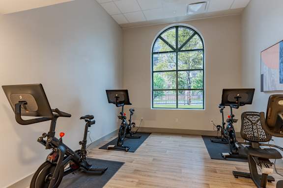 A room with exercise equipment and a window.