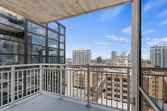 A balcony with a view of the cityscape.