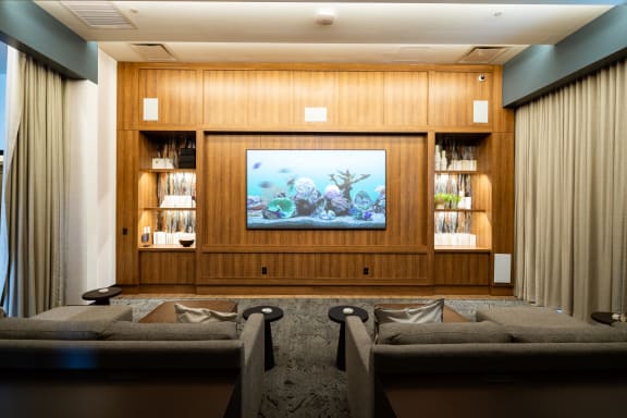 a living room with couches and a fish tank on the wall at 903 Peachtree, Georgia