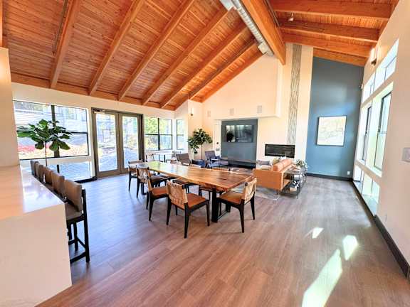 A dining room with a wooden table and chairs.
