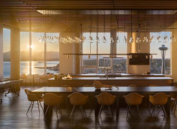 A modern dining room with a large table and chairs.