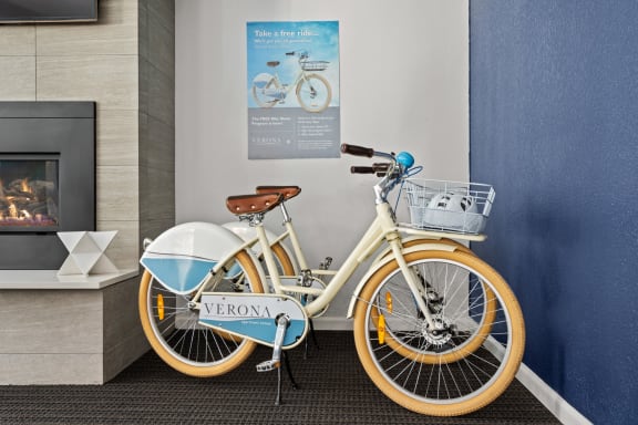 a bike parked next to a wall in a lobby at Verona, Littleton, CO