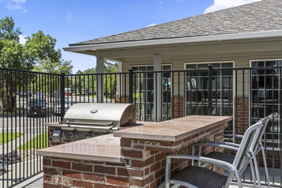 a patio with an outdoor grill and a table with chairs  at Verona, Littleton, 80123