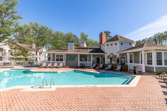 a large swimming pool with a house in the background at Briarcliff Apartments, Atlanta, GA