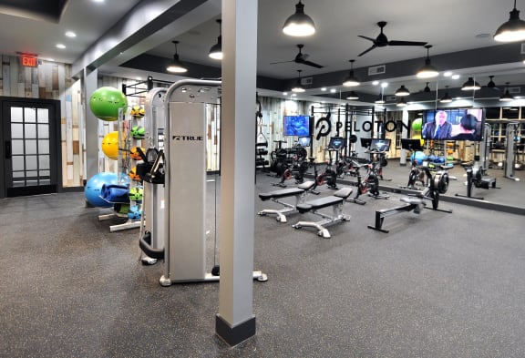 a gym with weights and other exercise equipment in a fitness center at Willowest in Lindbergh, Georgia, 30318