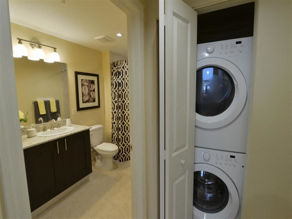 a bathroom with a washer and dryer in it at One Plantation, Plantation, 33324