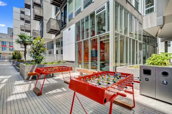 A red foosball table is in the middle of a courtyard at L Seven in San Francisco, CA