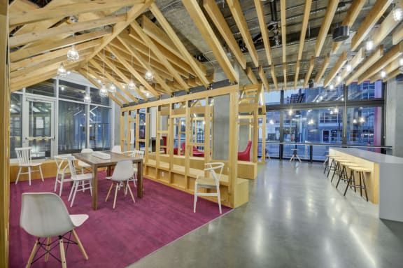 a dining room with tables and chairs and a building in the background at L Seven, California, 94103