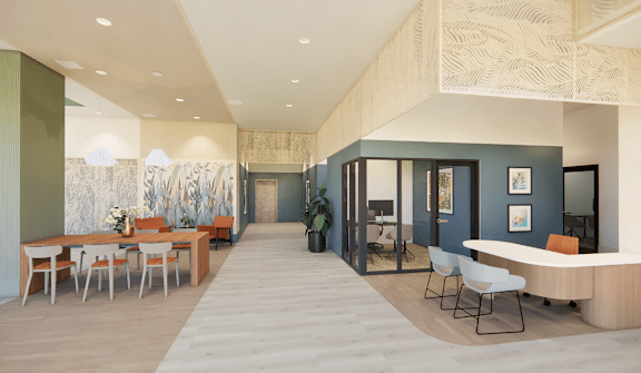 A modern office space with a long table and chairs.