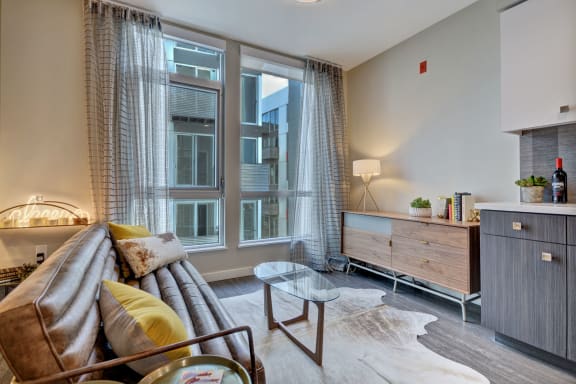 a living room with a couch and a large window at L Seven, CA 94103