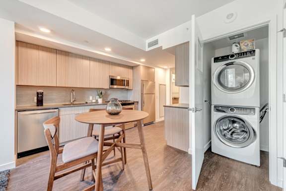 A modern kitchen with a table and chairs in the middle of the room.