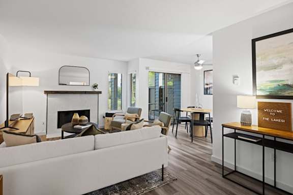a living room with a white couch and a fireplace