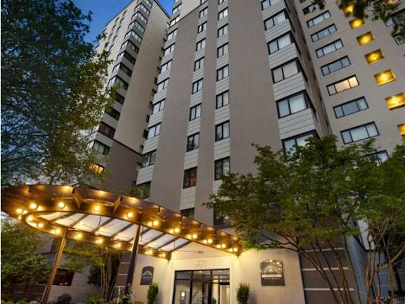 A tall building with a canopy in front of it at Skye at Belltown Apartments, Washington