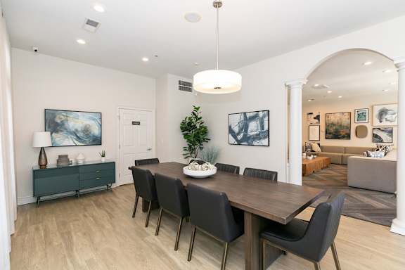 A dining room with a wooden table and chairs at Roswell Village
