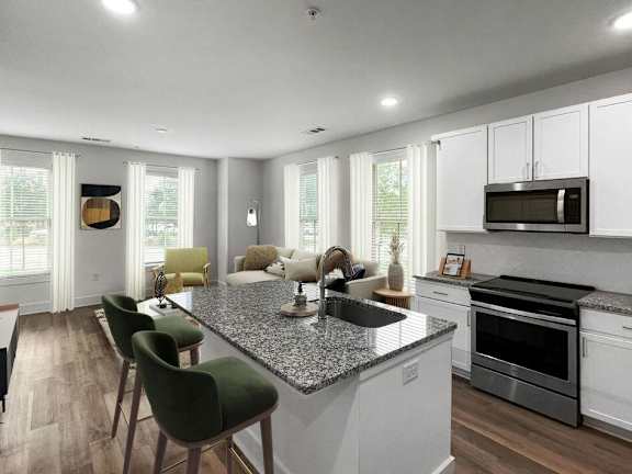 a kitchen and living room with a granite counter top at The Merchant Apartments, Charleston, South Carolina