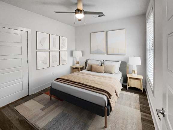 bedroom with a bed and a ceiling fan at The Merchant Apartments, Charleston