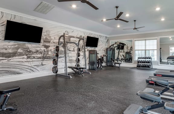 A spacious home gym with a variety of exercise equipment.