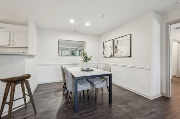 A dining room with a table and chairs.
