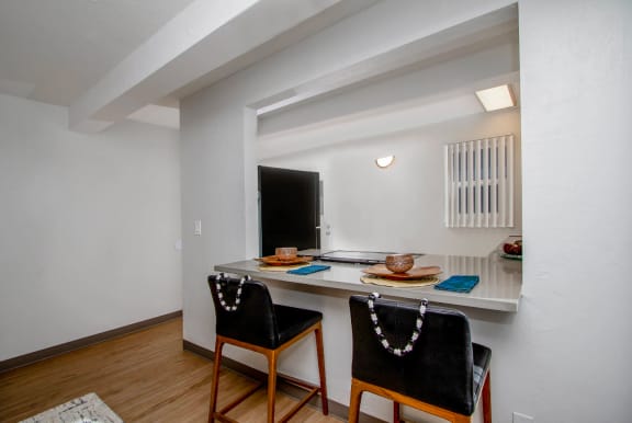 View of the breakfast bar facing the kitchen with a counter top and two chairs at Mala Grove in Hawaii, 96797