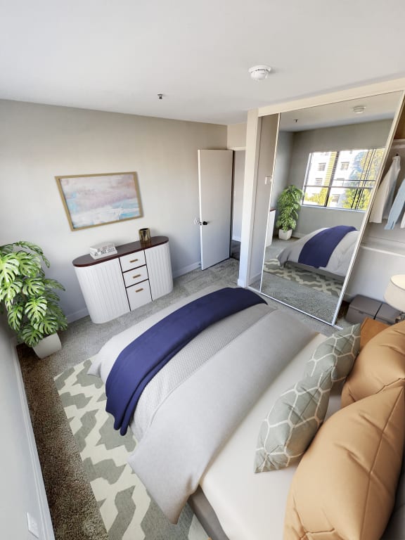 a bedroom with a bed and a mirror  at Duet on Wilcox, Los Angeles