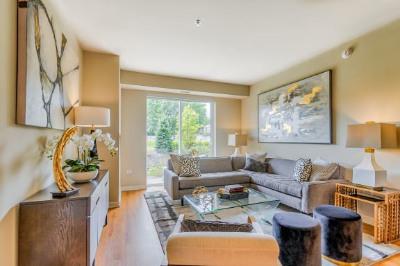 a living room with a couch and a glass coffee table at Avant at the Arboretum, Lisle, Illinois 60532