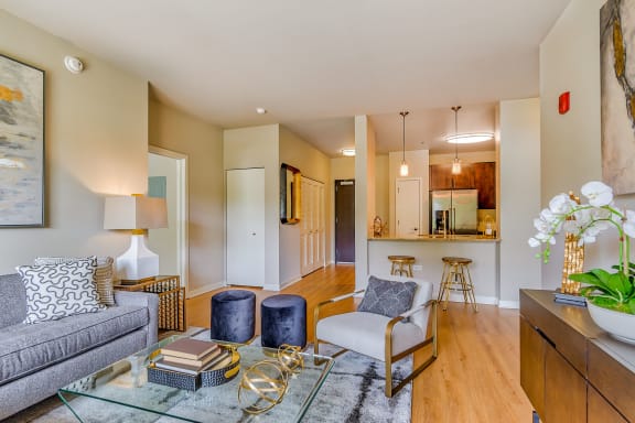 a living room with furniture and a glass table at Avant at the Arboretum, Lisle