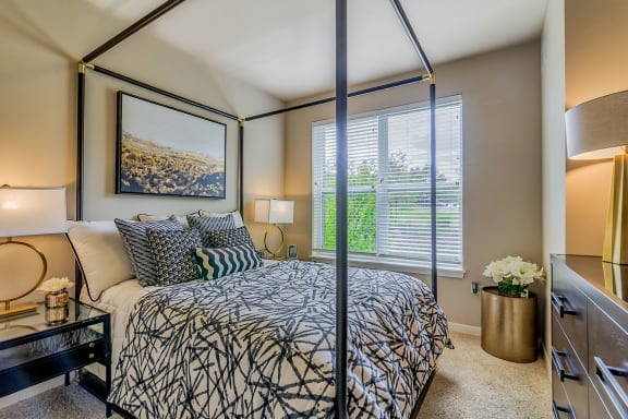 a bedroom with a large bed and a large window at Avant at the Arboretum, Illinois, 60532