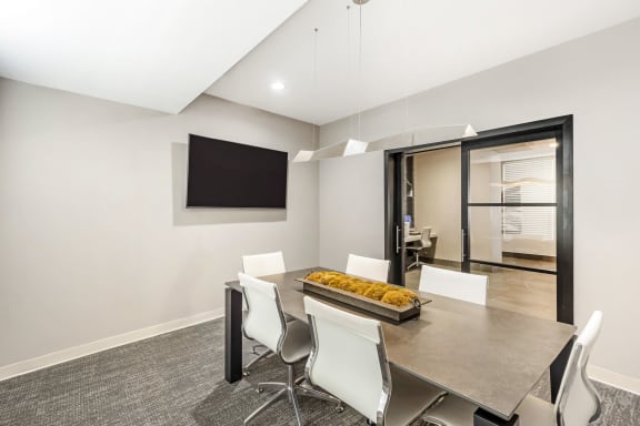 a dining room with a table and chairs at Avant at the Arboretum, Lisle, IL