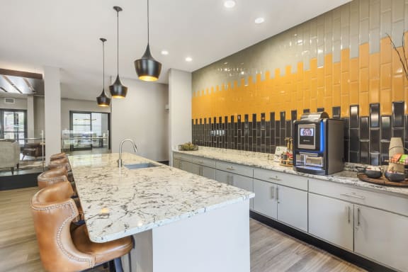 a kitchen with a marble counter top and a coffee machine at Avant at the Arboretum, Lisle, Illinois 60532
