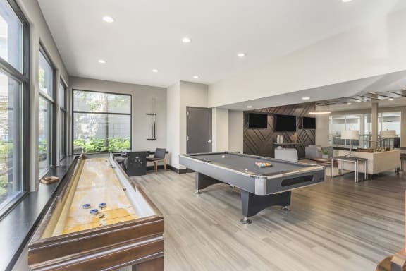 a game room with a shuffleboard table and a pool table at Avant at the Arboretum, Lisle, 60532