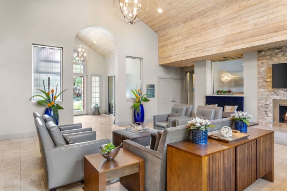 a living room with couches and tables and a fireplace at Aston at Cinco Ranch in Katy, Texas 77450