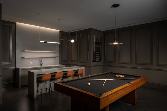 a dark room with a pool table and a bar  at The Belden Stratford, Illinois, 60614