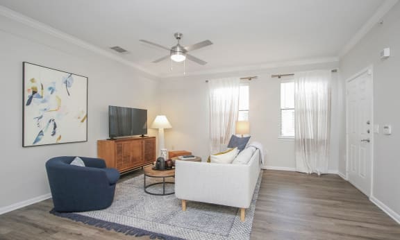 a living room with a ceiling fan and a couch at Sladestone Shadow Creek, Pearland, TX
