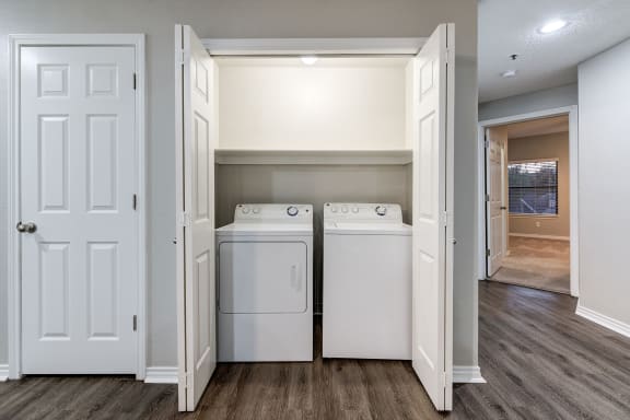 an empty laundry room with two washes and a dryer at Ashford Belmar Apartments, Lakewood, Colorado