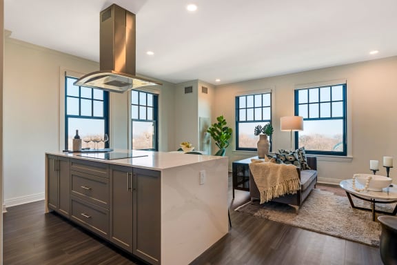 a large kitchen with a center island and a living room  at The Belden Stratford, Chicago, IL