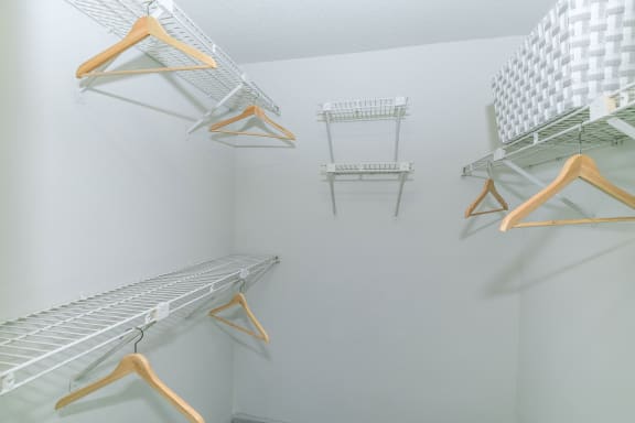 the walk in closet has two sets of hangers for clothes at Briarcliff Apartments, Atlanta, Georgia