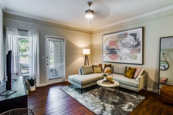 a living room with a couch and a table at Carrington at Barker Cypress, Cypress, TX, 77433