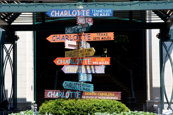 a sign with many different signs in front of a building at Highland Mill Lofts, North Carolina, 28205