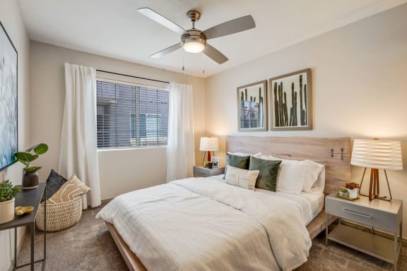 a bedroom with a large bed and a ceiling fan