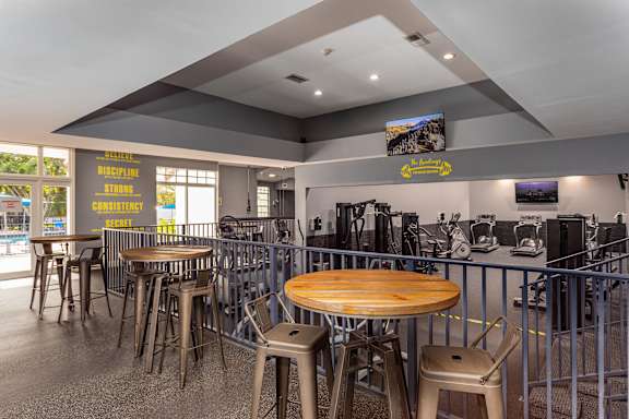 A restaurant with tables and chairs and a bar area.