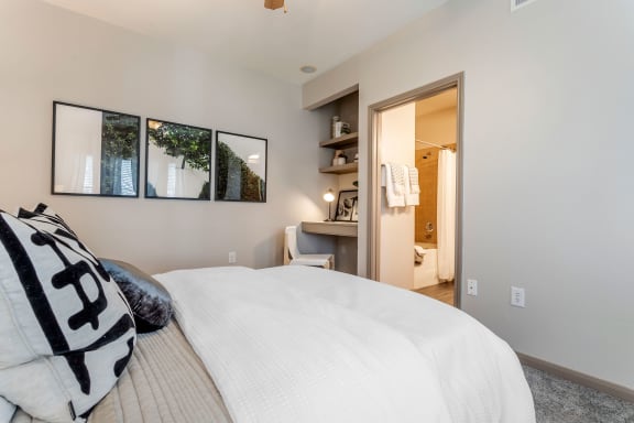 a master bedroom with a large bed and a bathroom at Reserve by the Lake, Houston