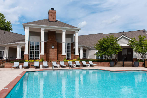 a resort-style swimming pool in front of a clubhouse at The Residences at Springfield Station, Springfield, VA, 22150