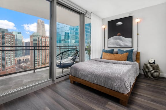 a bedroom with a large bed and a large window at Shoreham and Tides, Chicago, IL