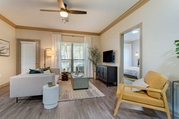 a living room with a ceiling fan and a couch at Summerwind, Pearland, TX 77584