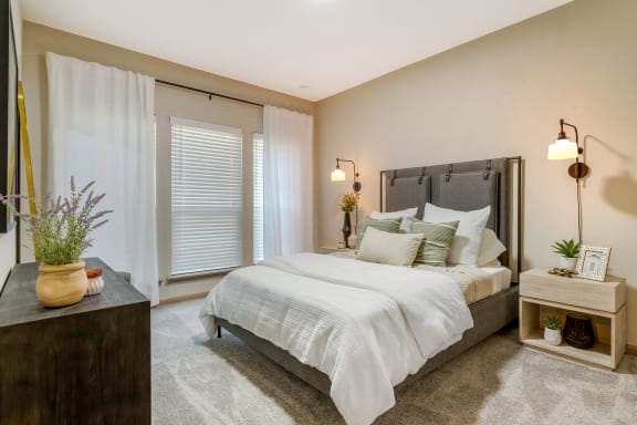 a bedroom with a bed and a window at Summerwind, Pearland, TX
