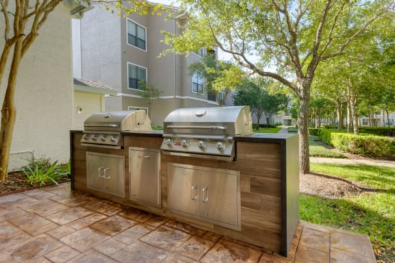 a stainless steel outdoor grill with two bbqs