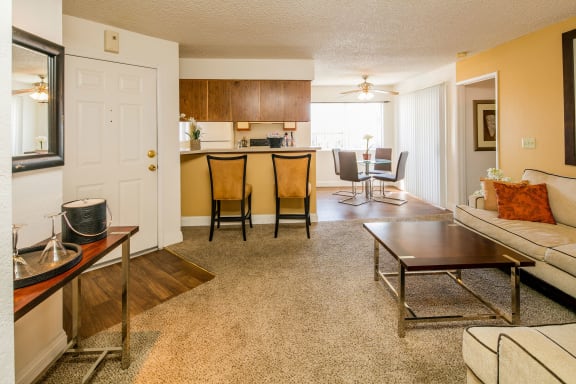 the view of a living room with a kitchen and a dining room at Sunset Winds Apartments, Henderson, NV